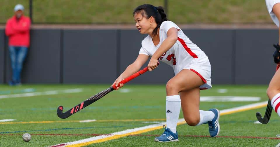 Field Hockey Winsor vs. Dexter Southfield 10/9/24 Student-athlete holds a field hockey stick and passes a ball
