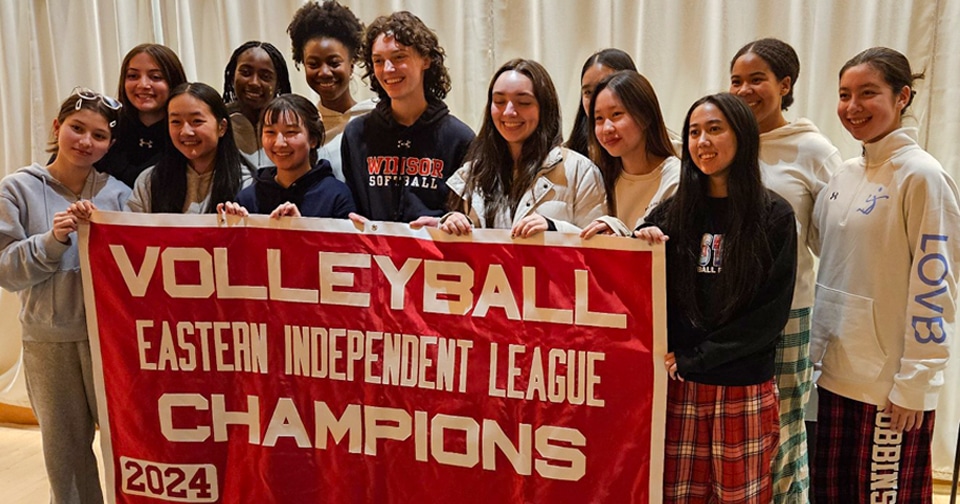 volleyball Volleyball athletes hold a banner