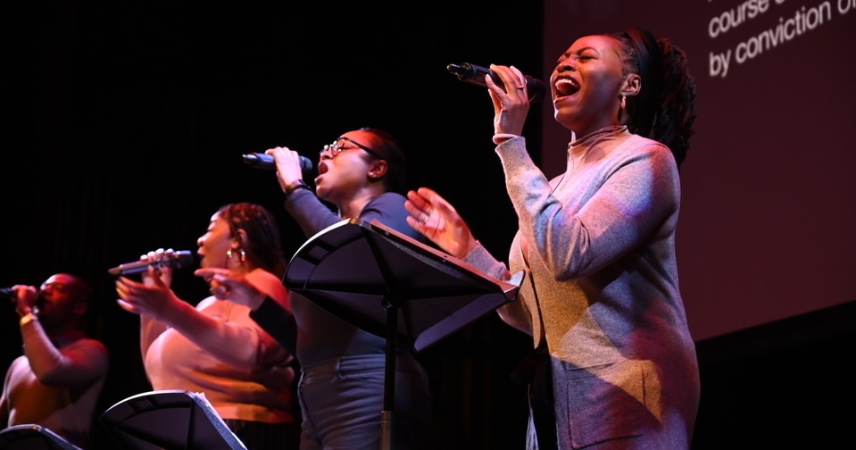 MLK Special Assembly Four vocalists singing on stage.