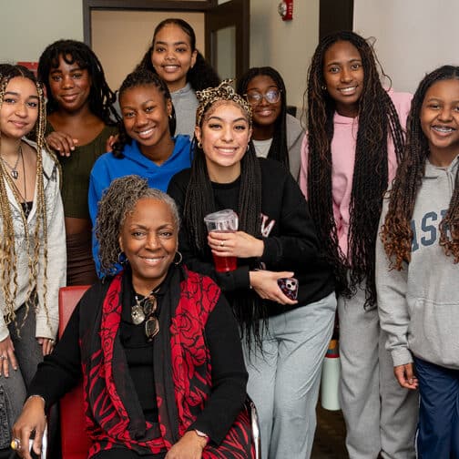 Group of students pose with artist Ekua Holmes