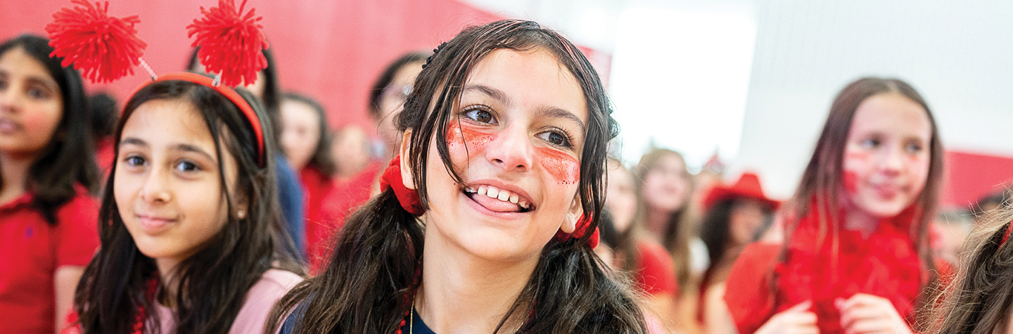 1440x475_UTLjpg young girls dressed in red with face paint smiling