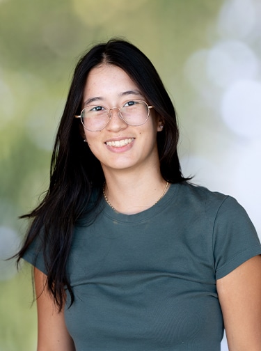 Young woman with dark hair and a blue t-shirt