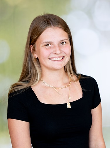 Young woman with sandy hair, wearing a black t-shirt