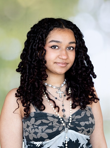 Young woman with dark, curly hair