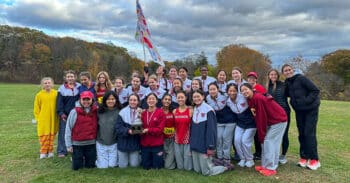 Team of athletes holds their trophy.