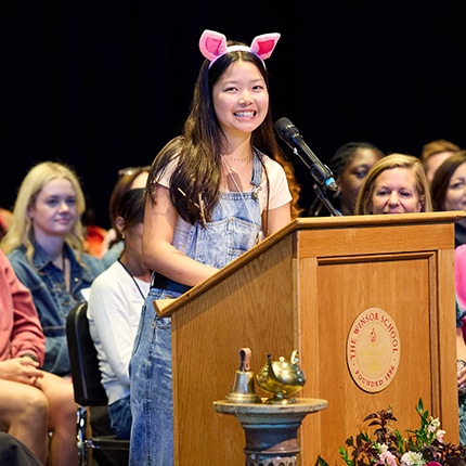 Young girl standing at podium