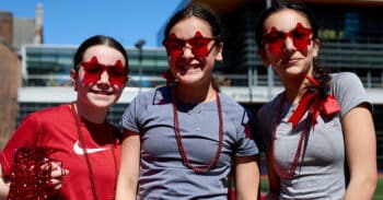 three girls wearing red star sunglasses