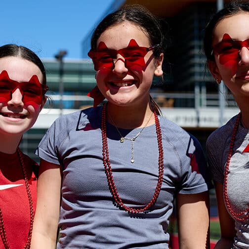 three girls wearing red star sunglasses