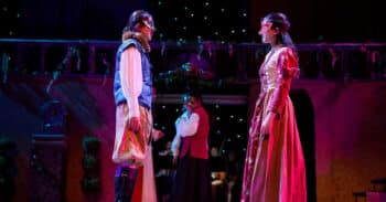 two students onstage in renaissance costumes