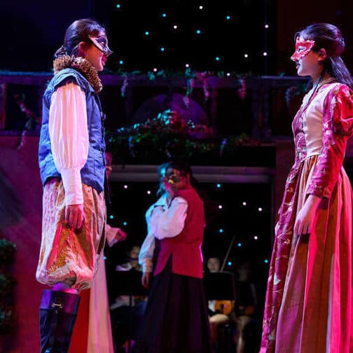 two students onstage in renaissance costumes