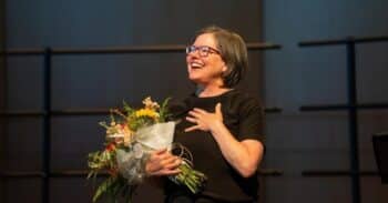 Woman holds a bouquet of flowers.